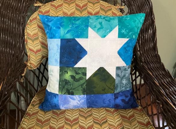 White Star Print on blue color pillow on chair